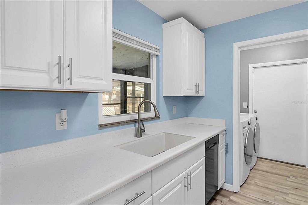 3409 Plaza Avenue Spring Hill, FL 34608 - Photo 11 of 41 a kitchen with stainless steel appliances granite countertop a sink and a microwave with wooden cabinets