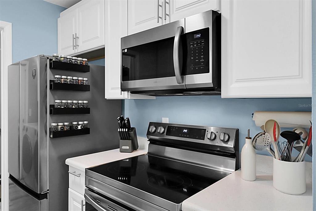 3409 Plaza Avenue Spring Hill, FL 34608 - Photo 12 of 41 a kitchen with stainless steel appliances granite countertop a stove and a microwave