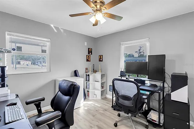 a view of a workspace with furniture and a window