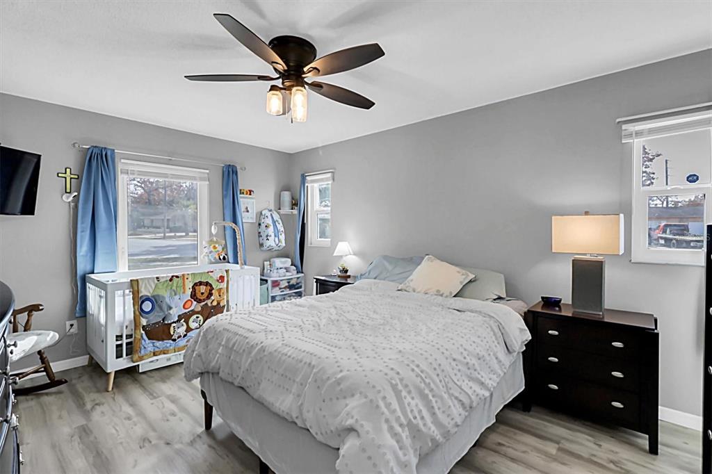 3409 Plaza Avenue Spring Hill, FL 34608 - Photo 19 of 41 a bedroom with a bed and wooden floor