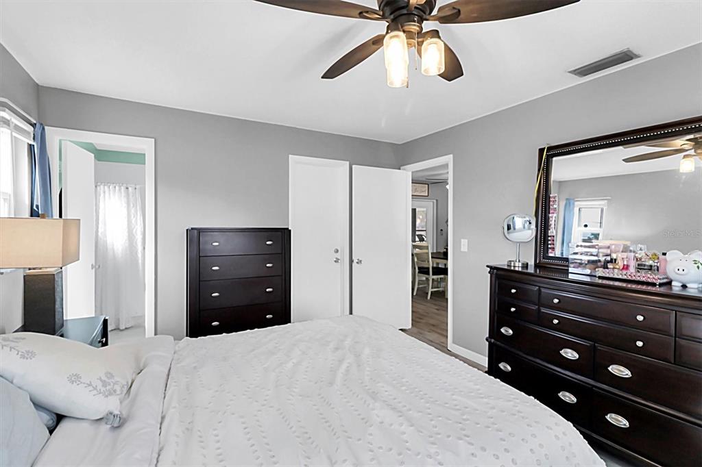 3409 Plaza Avenue Spring Hill, FL 34608 - Photo 20 of 41 a bedroom with a bed and a chandelier