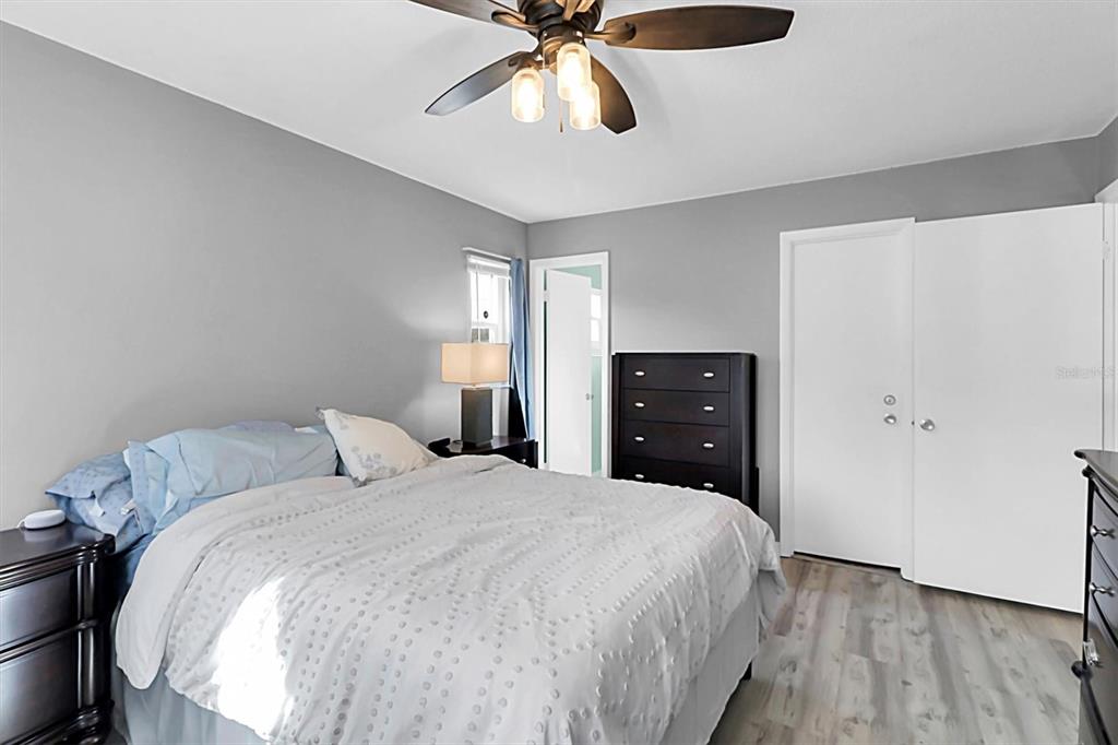 3409 Plaza Avenue Spring Hill, FL 34608 - Photo 21 of 41 a bedroom with a bed and a ceiling fan