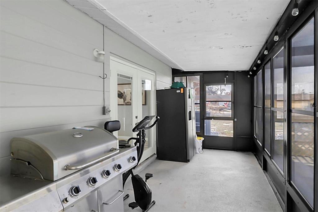 3409 Plaza Avenue Spring Hill, FL 34608 - Photo 22 of 41 a room with furniture a flat screen tv and a refrigerator