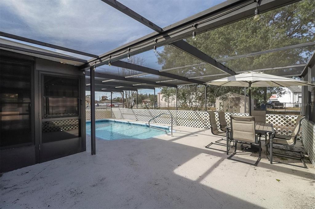 3409 Plaza Avenue Spring Hill, FL 34608 - Photo 27 of 41 a view of a backyard with table and chairs