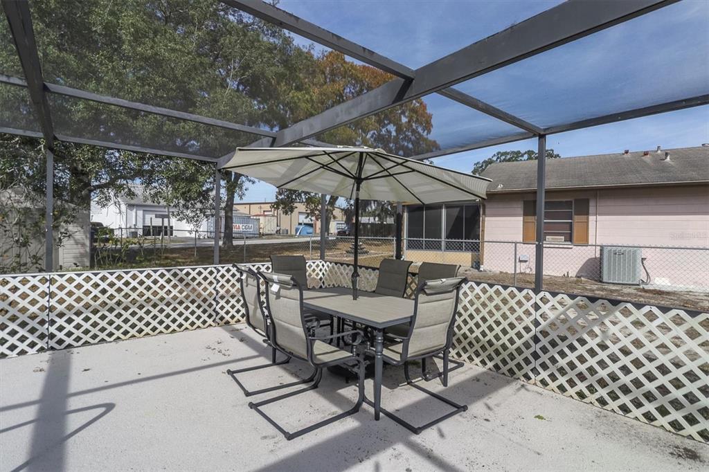 3409 Plaza Avenue Spring Hill, FL 34608 - Photo 28 of 41 a patio with table and chairs