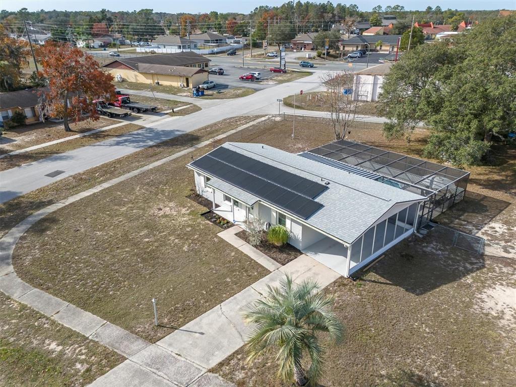 3409 Plaza Avenue Spring Hill, FL 34608 - Photo 39 of 41 an aerial view of a house with a yard wooden table and chairs