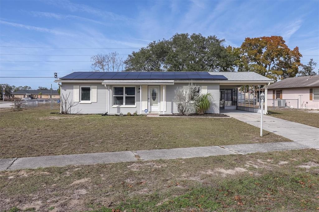3409 Plaza Avenue Spring Hill, FL 34608 - Photo 5 of 41 a front view of a house with a garden