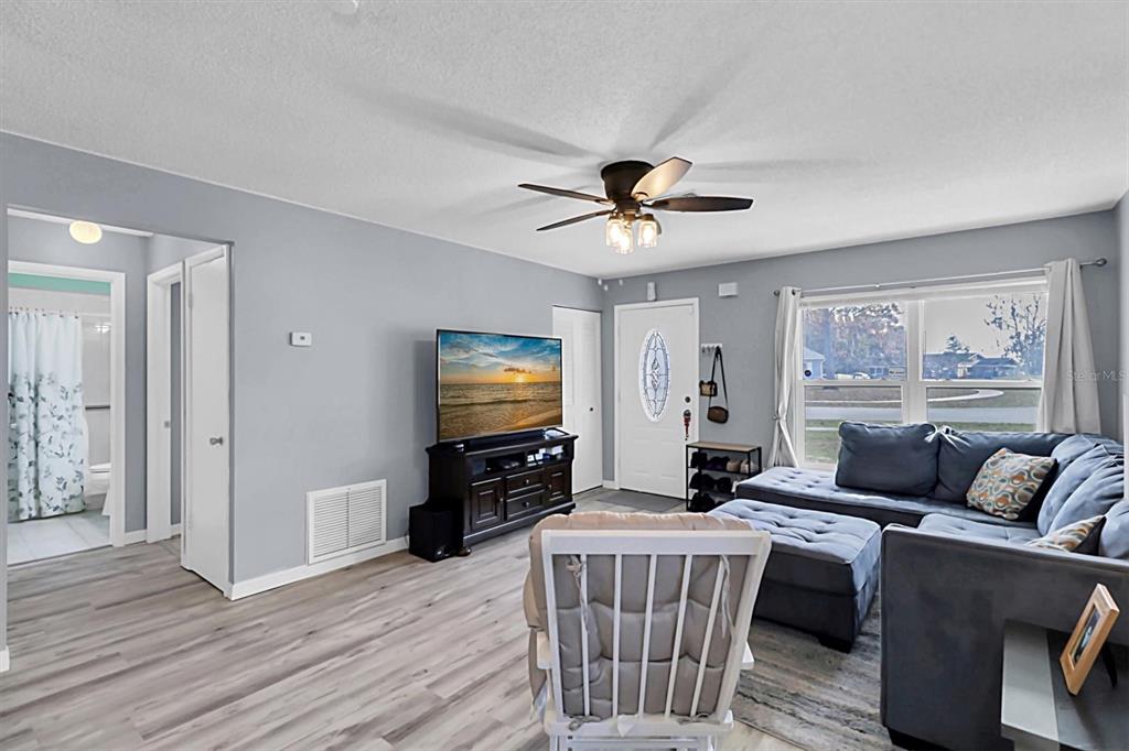 3409 Plaza Avenue Spring Hill, FL 34608 - Photo 6 of 41 a living room with furniture and a flat screen tv