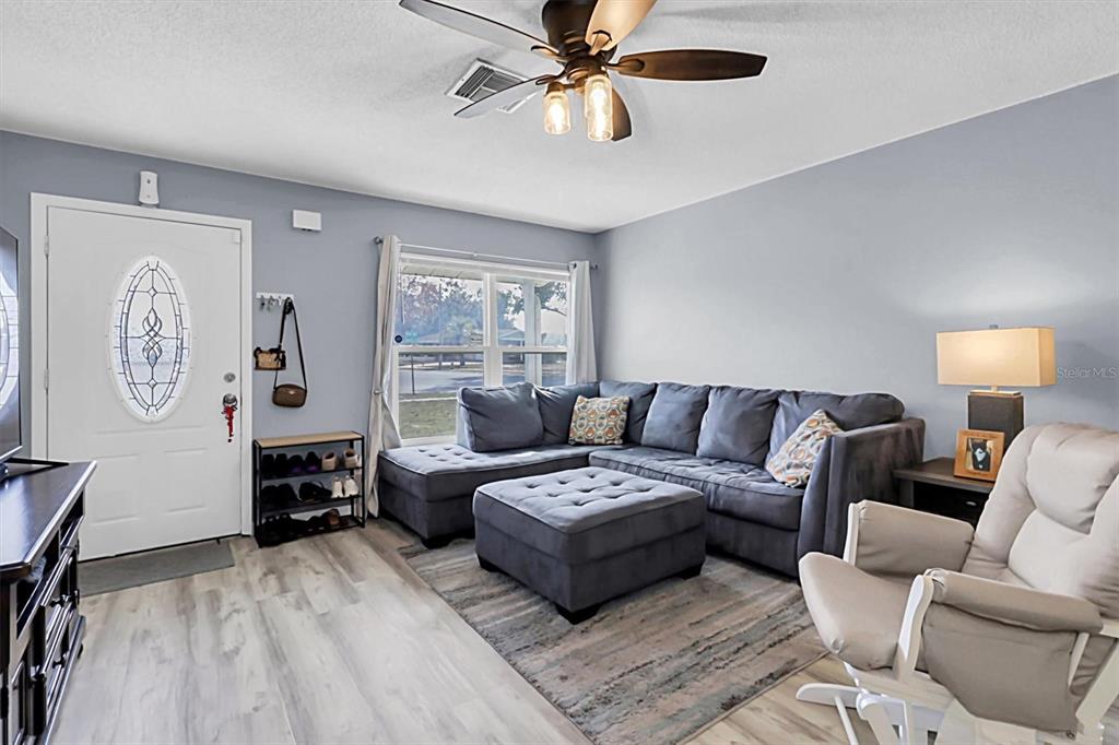 3409 Plaza Avenue Spring Hill, FL 34608 - Photo 7 of 41 a living room with furniture and a window