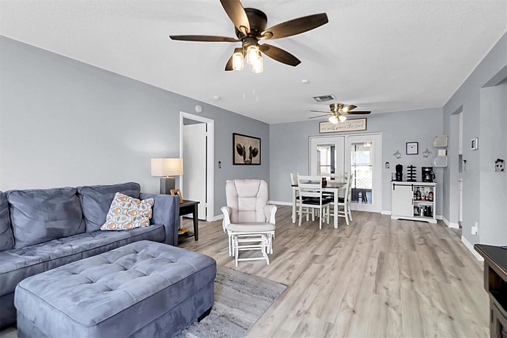 3409 Plaza Avenue Spring Hill, FL 34608 - Photo 8 of 41 a living room with furniture and a wooden floor
