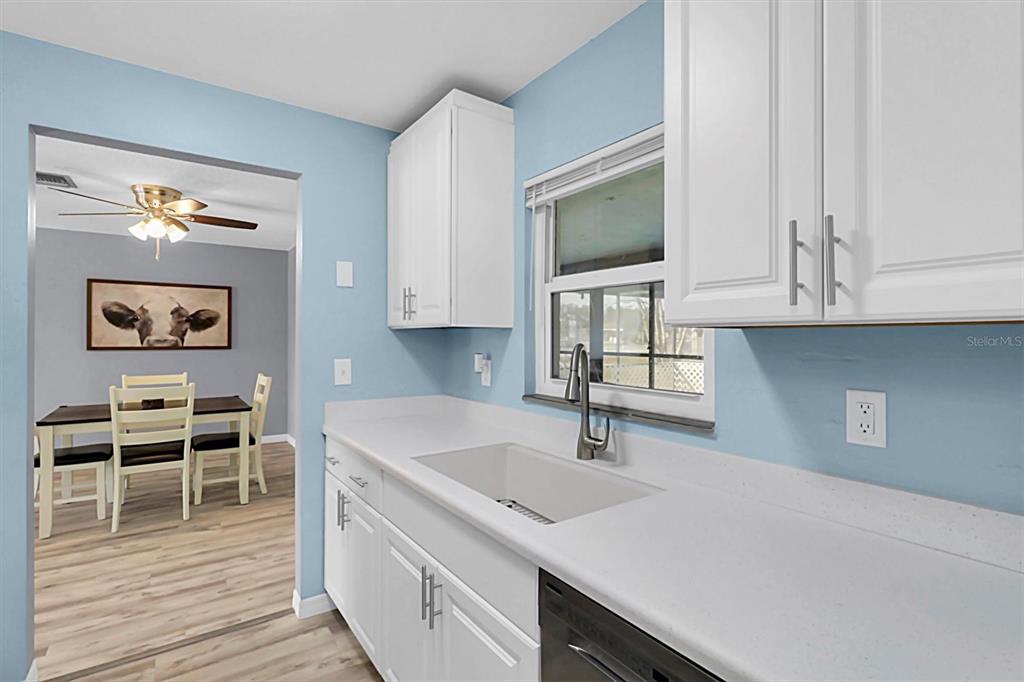3409 Plaza Avenue Spring Hill, FL 34608 - Photo 10 of 41 a kitchen with stainless steel appliances granite countertop a sink and a microwave
