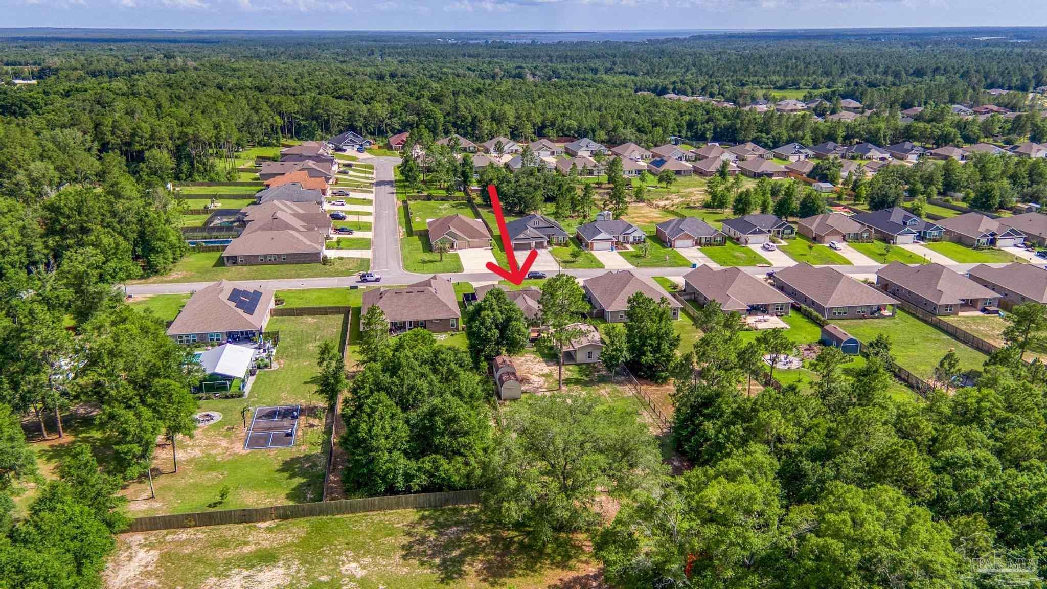 8114 Silver Maple Drive Milton, FL 32583 - Photo 31 of 32 an aerial view of residential houses with outdoor space and swimming pool