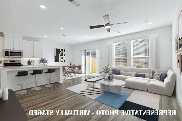 a living room with furniture and kitchen view