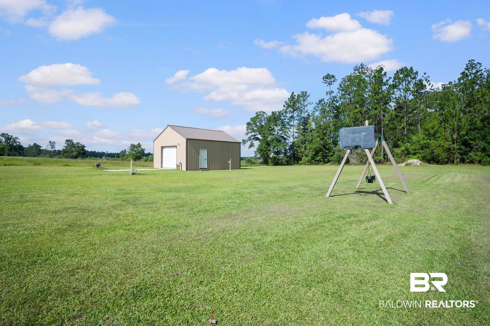 48513 Phillipsville Road Bay Minette, AL 36507 - Photo 50 of 50 View of grassy yard featuring a garage and an outdoor structure
