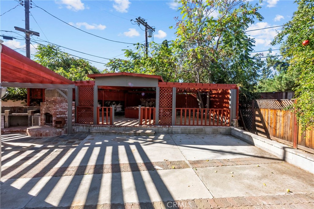 7839 Lena Avenue West Hills, CA 91304 - Photo 15 of 65 a view of a patio with table and chairs potted plants with wooden floor and fence
