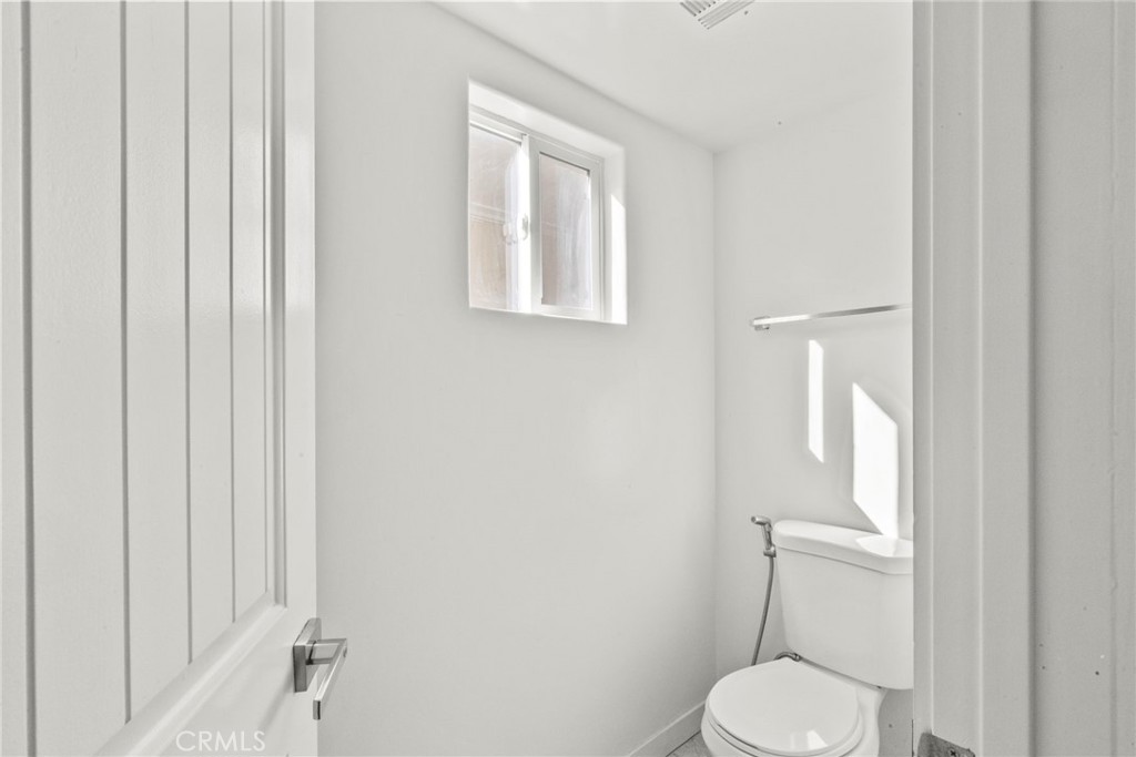 7839 Lena Avenue West Hills, CA 91304 - Photo 21 of 65 a white toilet sitting next to a bathroom sink