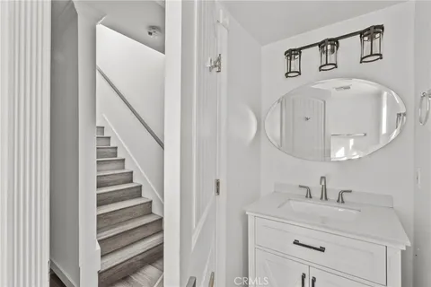 a bathroom with a sink a toilet and a window