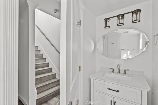 a bathroom with a sink a toilet and a window