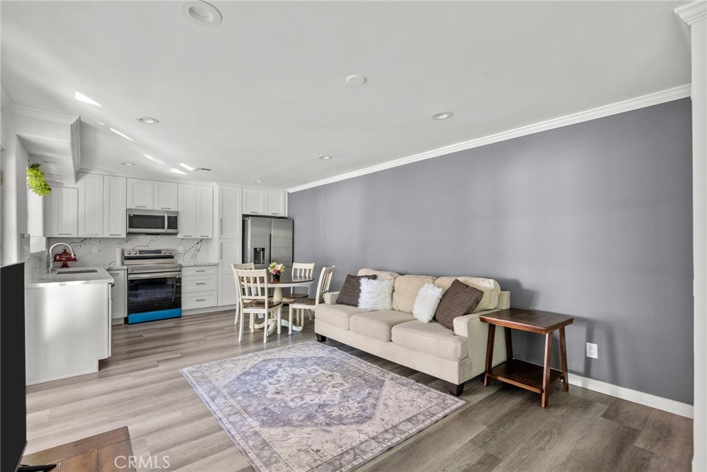 7839 Lena Avenue West Hills, CA 91304 - Photo 25 of 65 a living room with furniture and a dining table with kitchen view