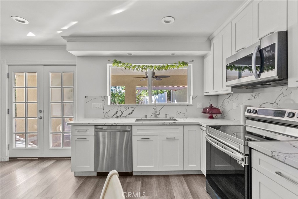7839 Lena Avenue West Hills, CA 91304 - Photo 27 of 65 a kitchen with a sink stove and microwave