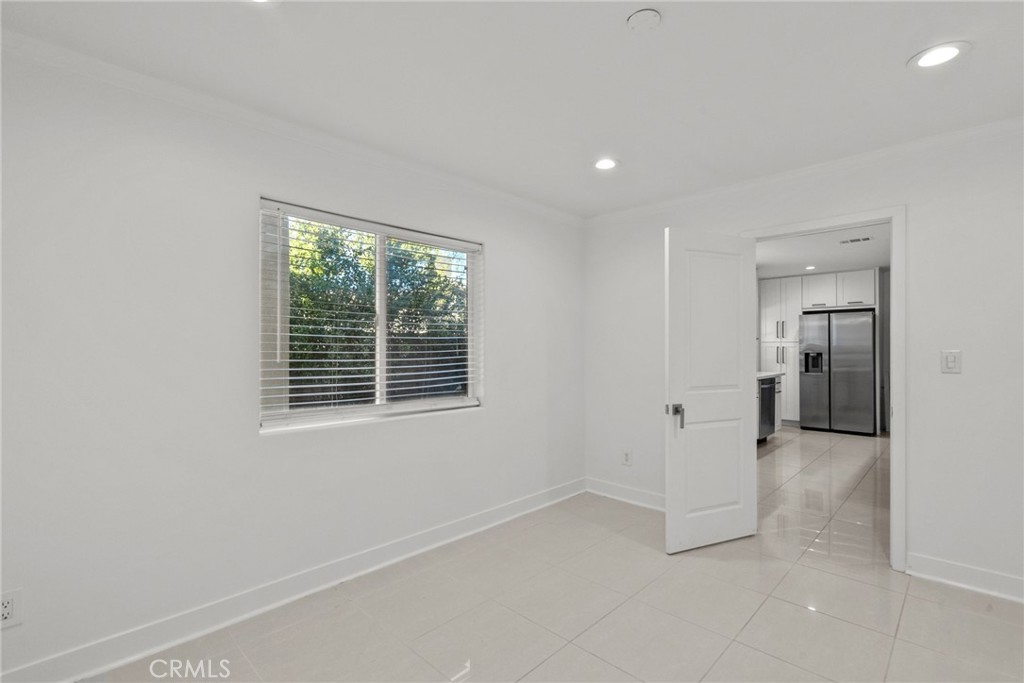 7839 Lena Avenue West Hills, CA 91304 - Photo 28 of 65 an empty room with a window and a kitchen