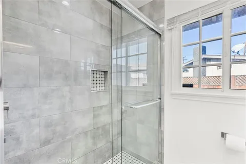 a view of kitchen with kitchen island stainless steel appliances refrigerator stove microwave and cabinets