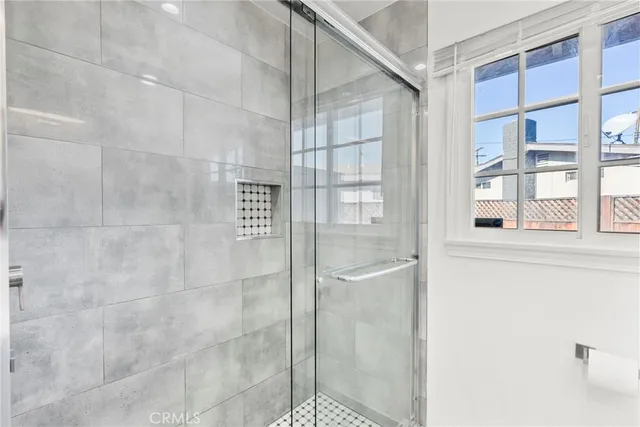 a view of kitchen with kitchen island stainless steel appliances refrigerator stove microwave and cabinets