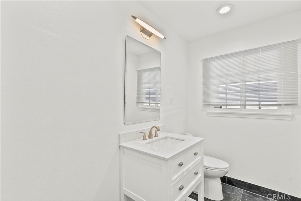 7839 Lena Avenue West Hills, CA 91304 - Photo 32 of 65 a bathroom with a sink a toilet and a window