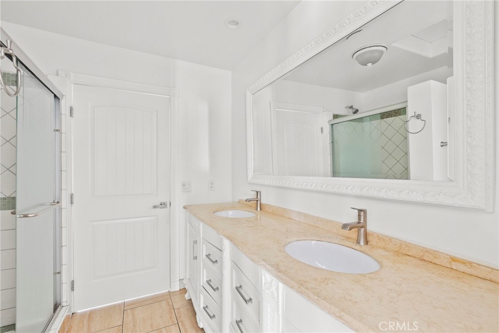7839 Lena Avenue West Hills, CA 91304 - Photo 38 of 65 a bathroom with a granite countertop sink and a mirror