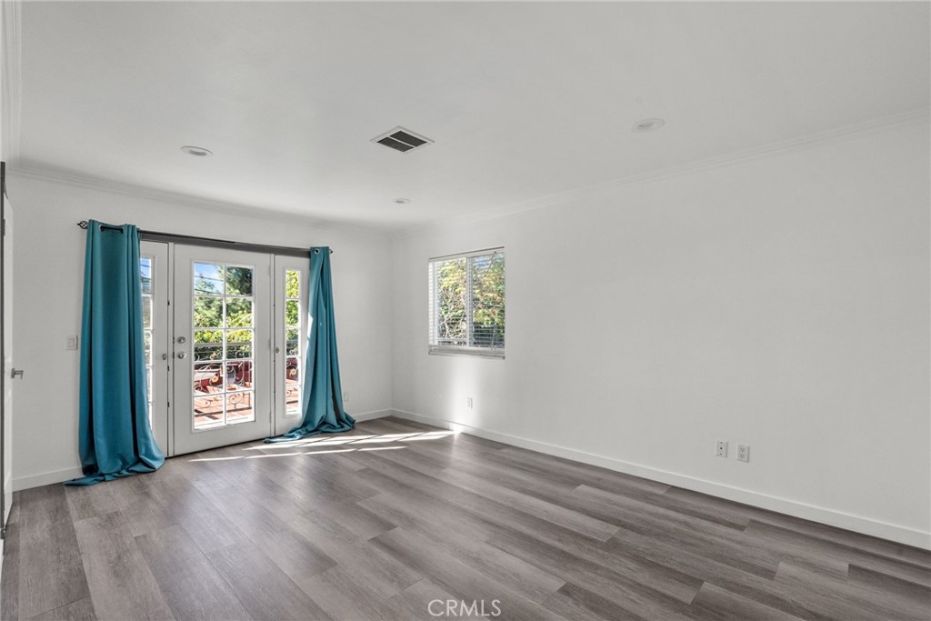 7839 Lena Avenue West Hills, CA 91304 - Photo 39 of 65 an empty room with wooden floor and windows