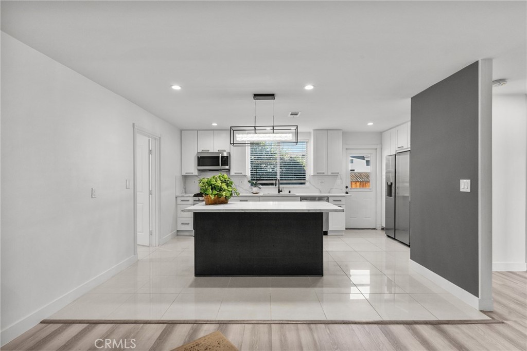 7839 Lena Avenue West Hills, CA 91304 - Photo 42 of 65 a view of kitchen with kitchen island stainless steel appliances refrigerator stove microwave and cabinets