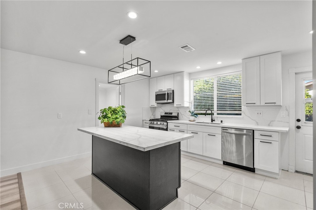 7839 Lena Avenue West Hills, CA 91304 - Photo 44 of 65 a kitchen with a sink stove and cabinets