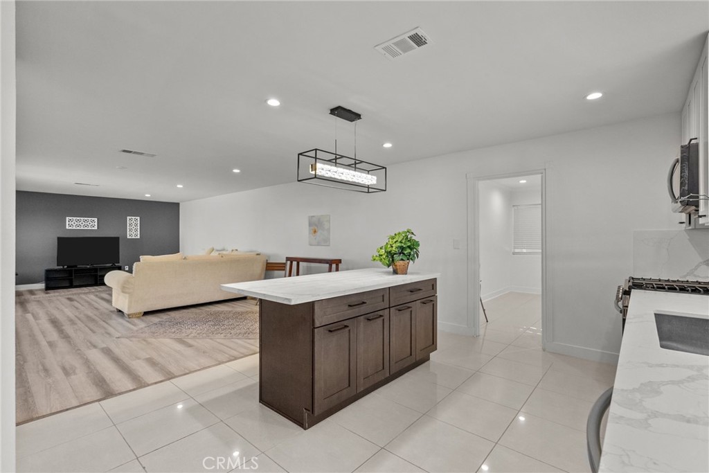 7839 Lena Avenue West Hills, CA 91304 - Photo 47 of 65 a kitchen with stainless steel appliances granite countertop a sink and a refrigerator