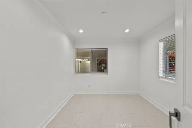 a bedroom with a bed and glass door