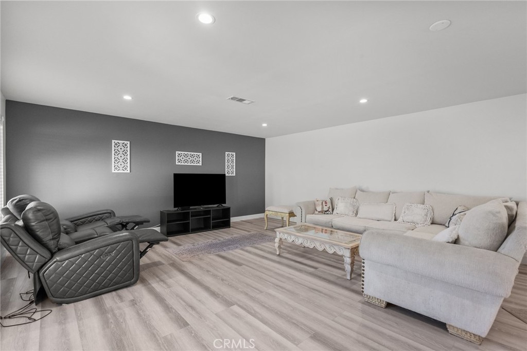 7839 Lena Avenue West Hills, CA 91304 - Photo 52 of 65 a living room with furniture a flat screen tv and a couch
