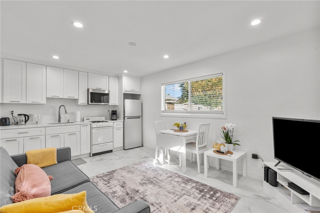 7839 Lena Avenue West Hills, CA 91304 - Photo 56 of 65 a living room with stainless steel appliances furniture a rug and a kitchen view