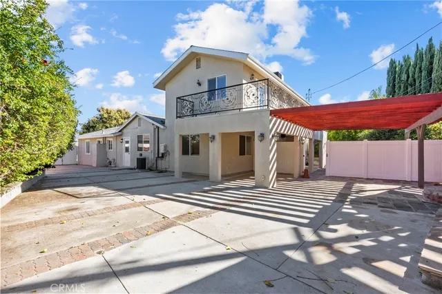a view of a patio with table and chairs potted plants with wooden floor and fence