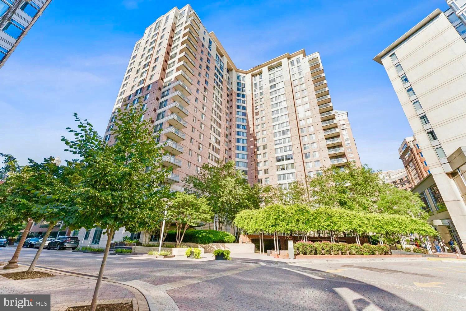 a view of a tall building next to a road