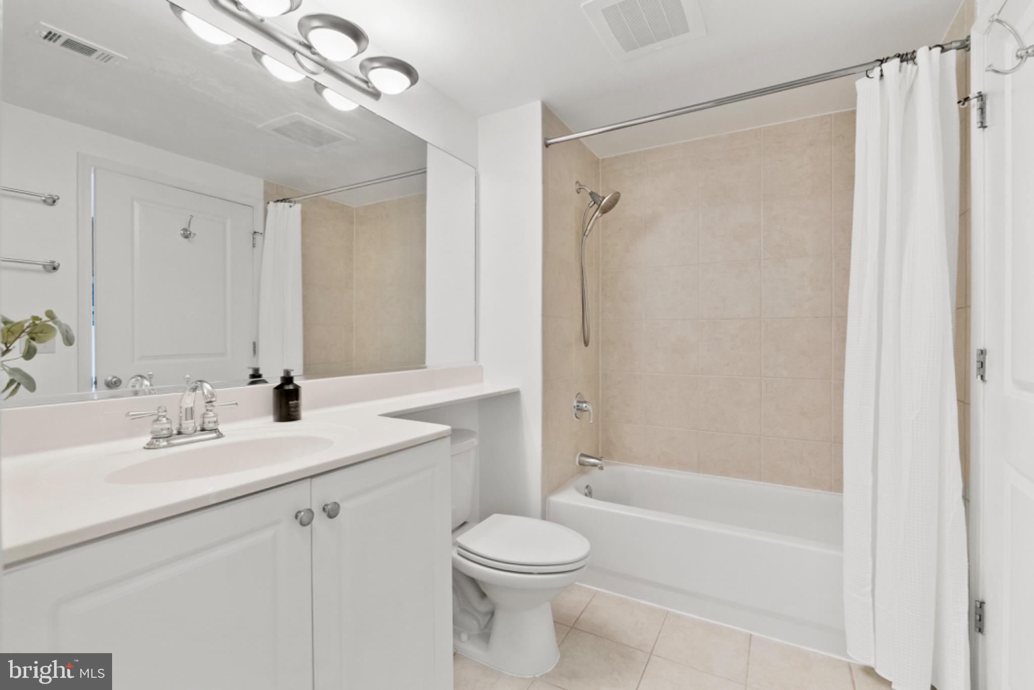 851 North Glebe Road, Unit 1712 Arlington, VA 22203 - Photo 11 of 25 a bathroom with a sink a toilet and shower