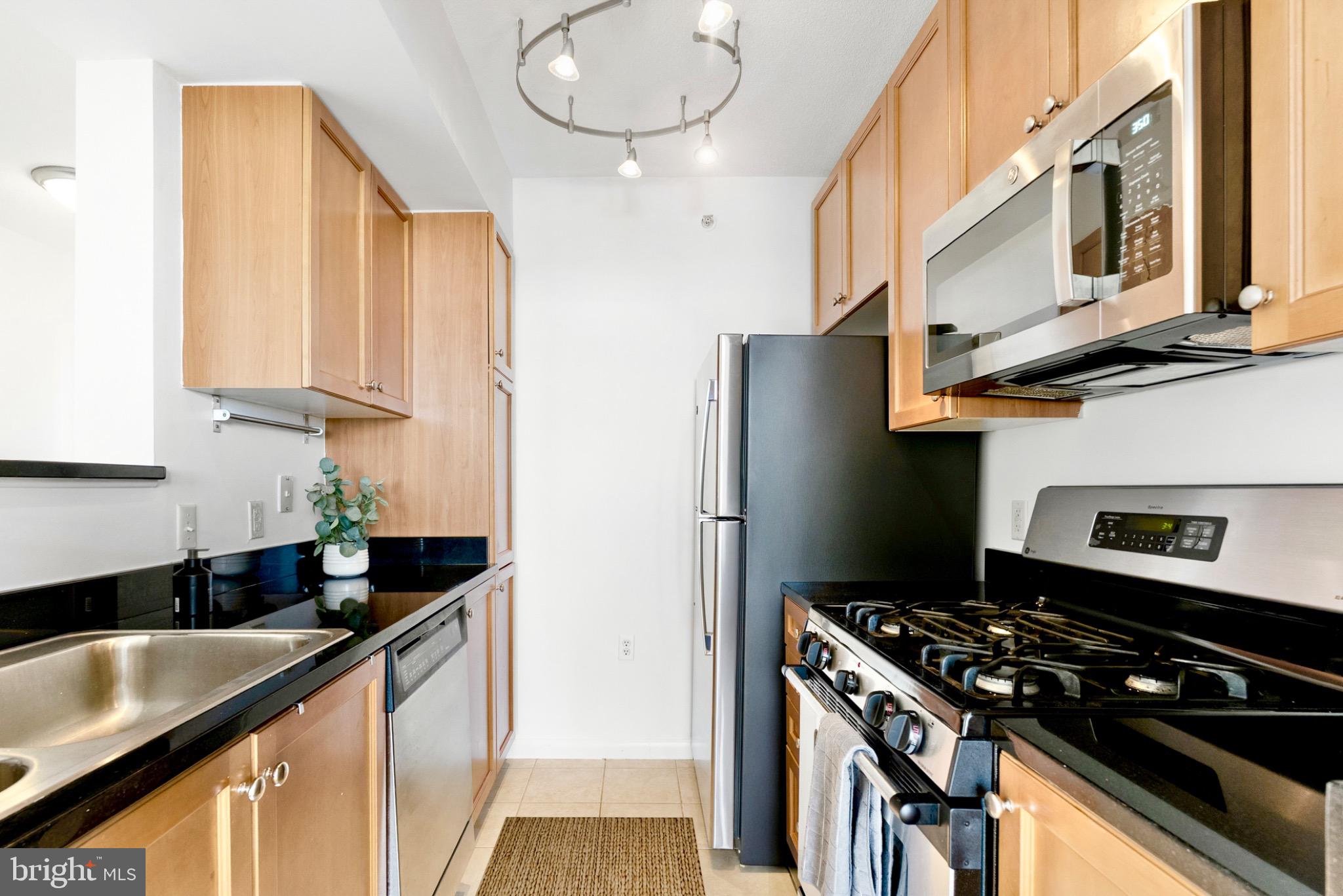 851 North Glebe Road, Unit 1712 Arlington, VA 22203 - Photo 3 of 25 a kitchen with stainless steel appliances granite countertop a sink stove and refrigerator