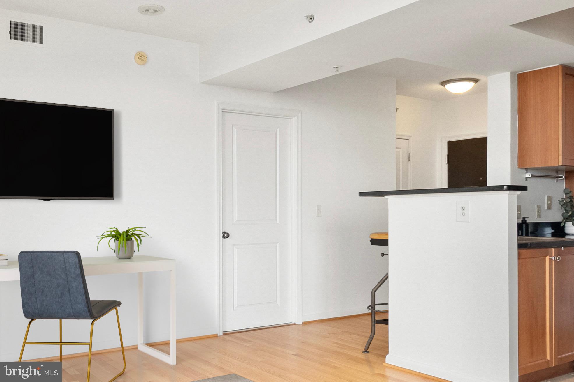 851 North Glebe Road, Unit 1712 Arlington, VA 22203 - Photo 4 of 25 a living room with furniture and a flat screen tv