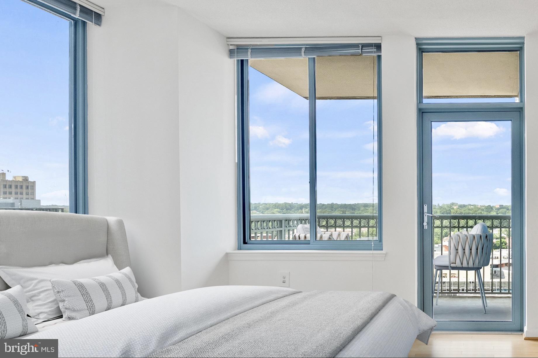 851 North Glebe Road, Unit 1712 Arlington, VA 22203 - Photo 7 of 25 a bedroom with a large window and a bed