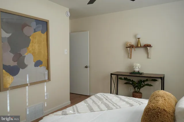 a bedroom with a bed and a table