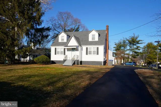 a front view of a house with a garden and yard