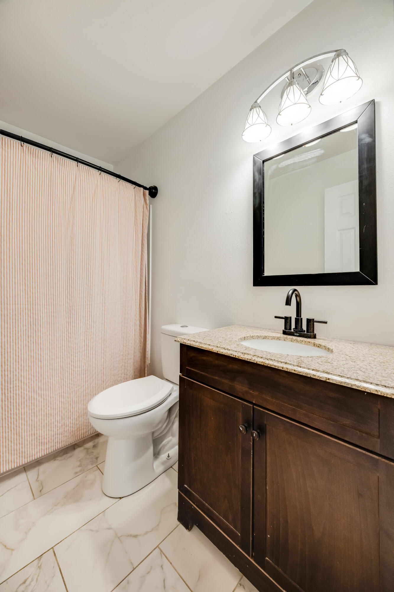 966 Valley Road Crestview, FL 32539 - Photo 18 of 32 a bathroom with a toilet sink and mirror