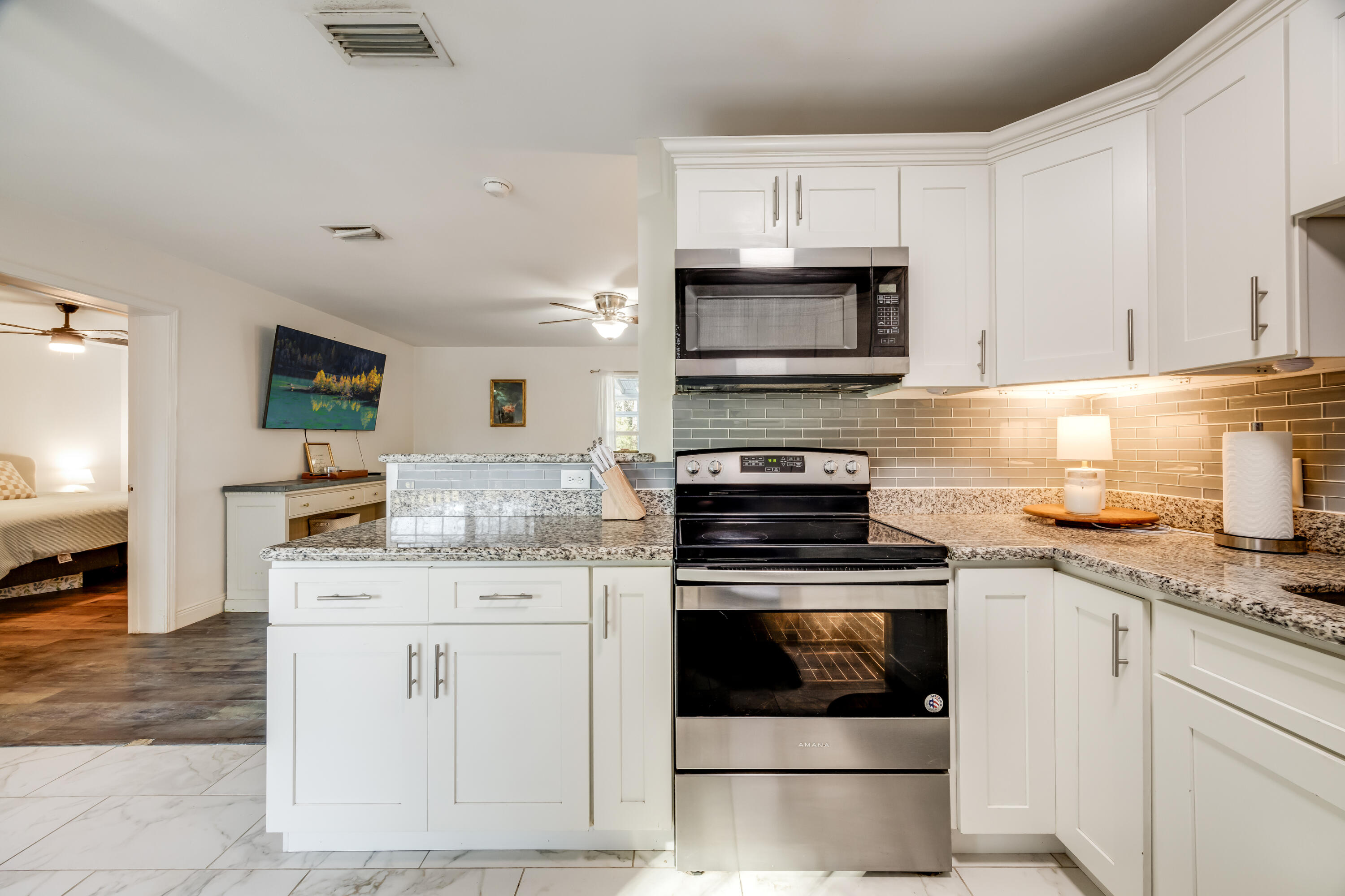 966 Valley Road Crestview, FL 32539 - Photo 29 of 32 a kitchen with granite countertop a stove sink and microwave