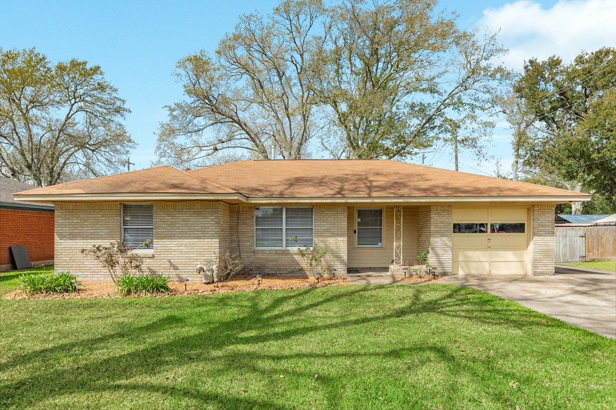 a front view of house with yard and outdoor seating