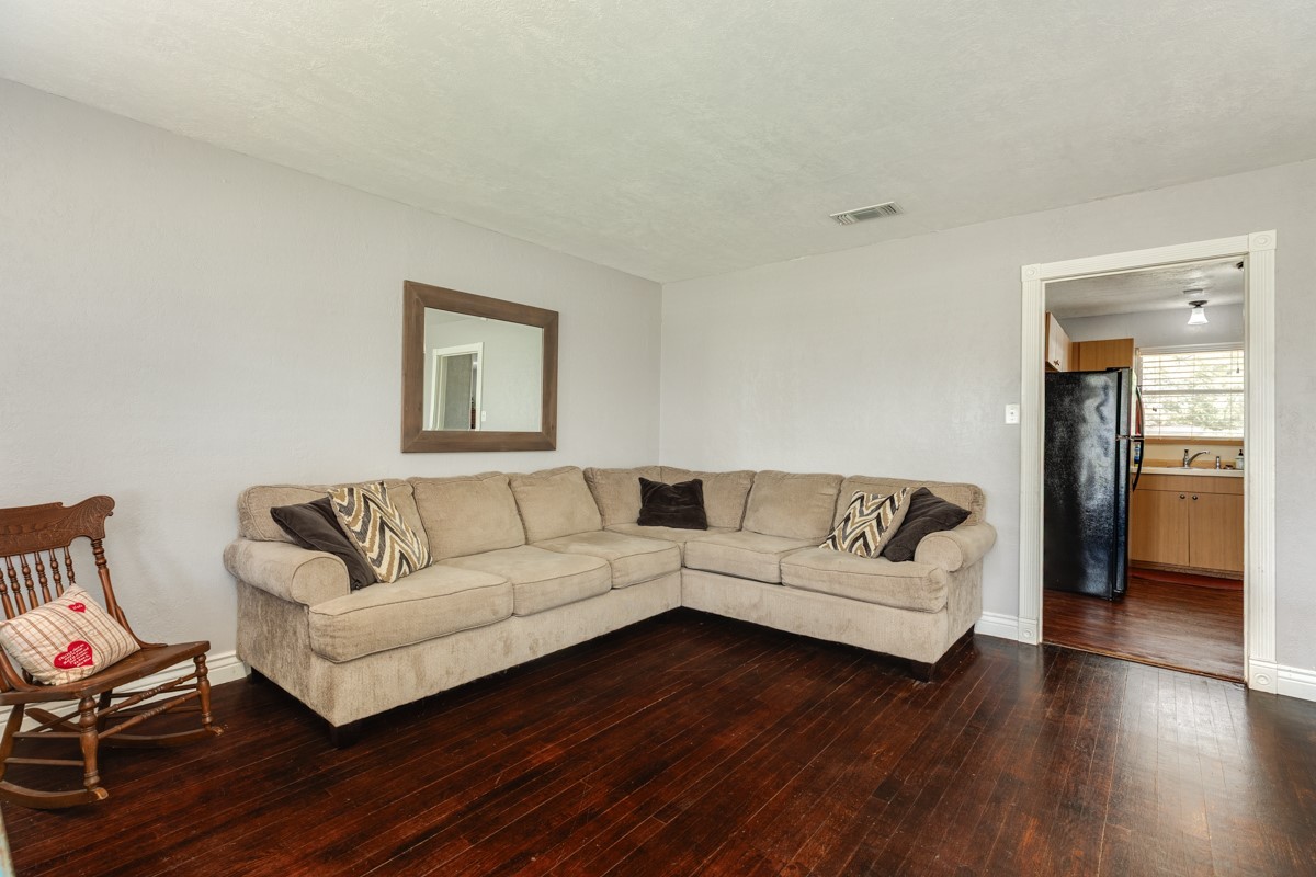 2109 North Tinsley Street Angleton, TX 77515 - Photo 11 of 27 a living room with couches and a night stand