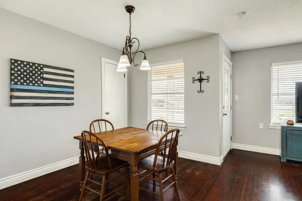 a view of a dining room with furniture wooden floor and chandelier
