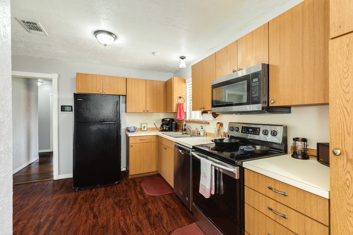 2109 North Tinsley Street Angleton, TX 77515 - Photo 15 of 27 a kitchen with a refrigerator stove and microwave